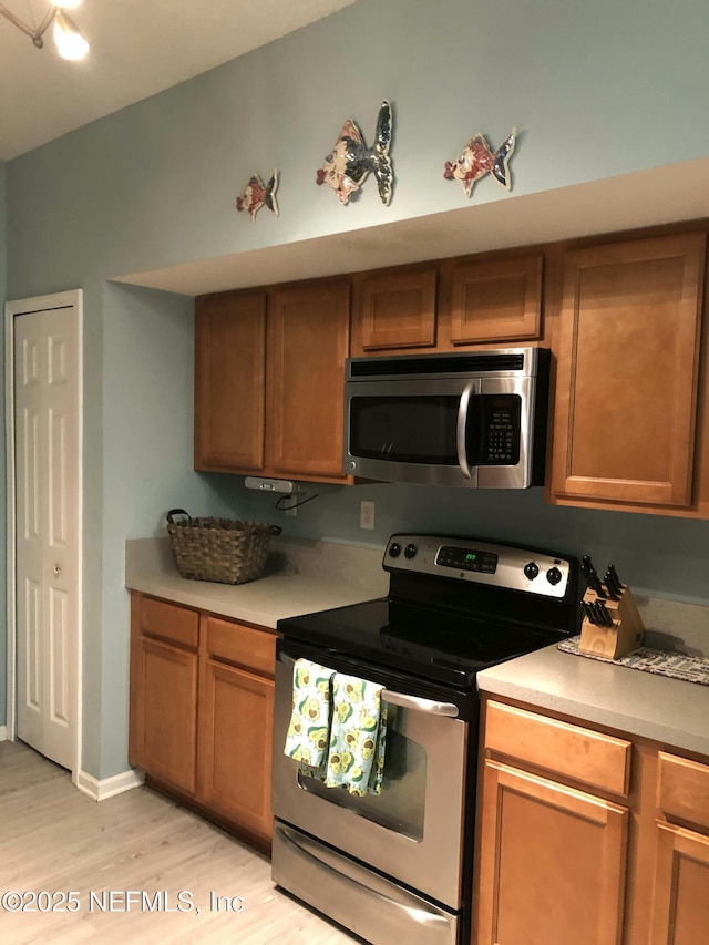 kitchen with appliances with stainless steel finishes and light wood-type flooring