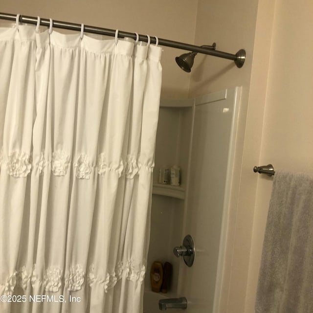 bathroom with shower / bath combination with curtain