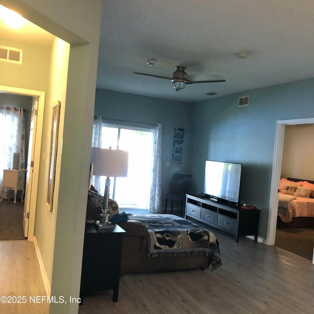 bedroom with ceiling fan and wood-type flooring