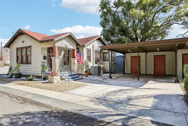 view of front of property with a carport and cooling unit