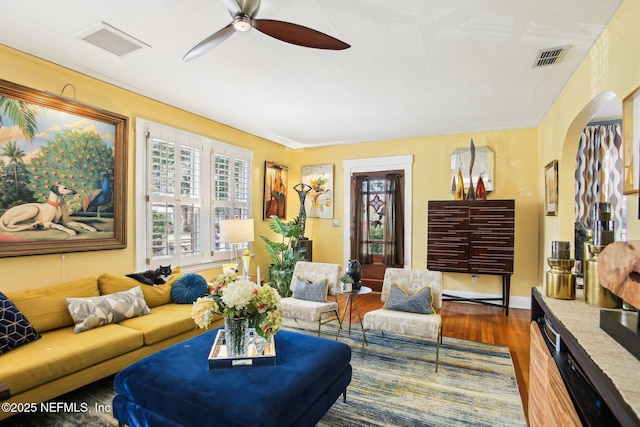 living room featuring ceiling fan and hardwood / wood-style floors