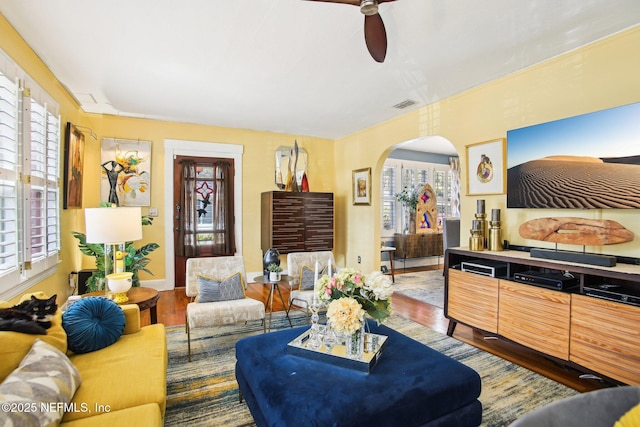 living room with ceiling fan, a wealth of natural light, and wood-type flooring