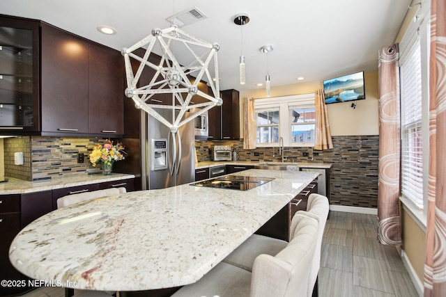 kitchen featuring dark brown cabinetry and a center island