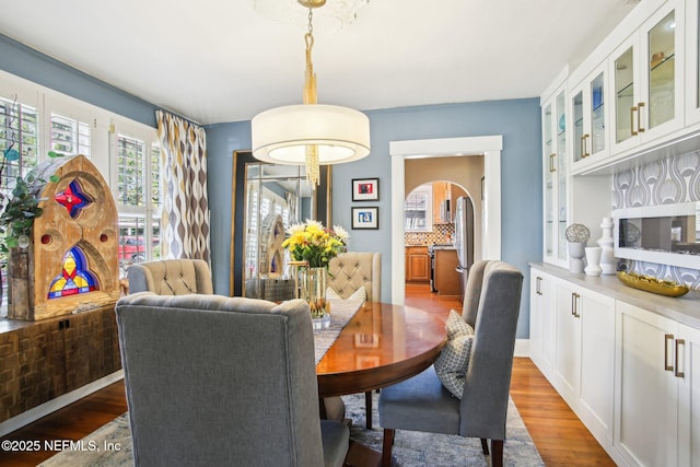 dining space with hardwood / wood-style flooring