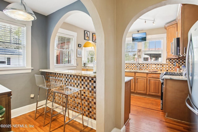 interior space with hardwood / wood-style floors, track lighting, and sink