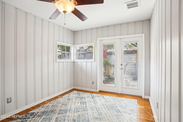 spare room with light hardwood / wood-style floors, french doors, and ceiling fan