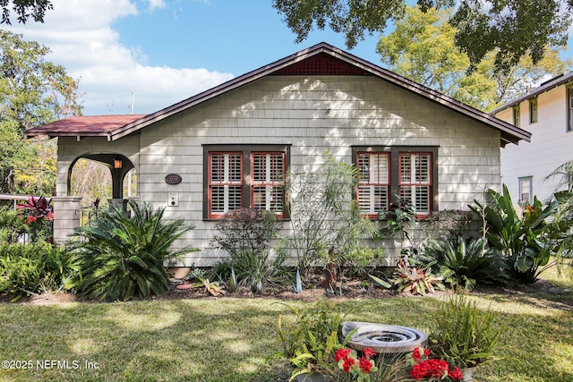 view of side of property with a yard