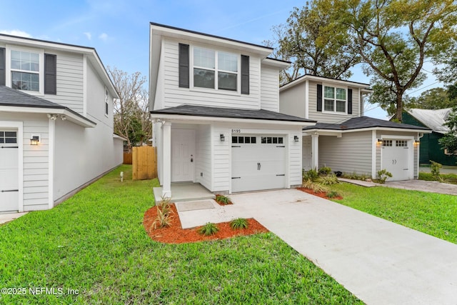 view of front property featuring a garage and a front yard