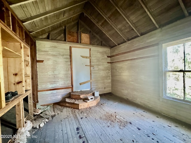 misc room featuring wood-type flooring, vaulted ceiling with beams, wood ceiling, and wooden walls