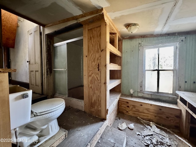 bathroom featuring an enclosed shower and toilet