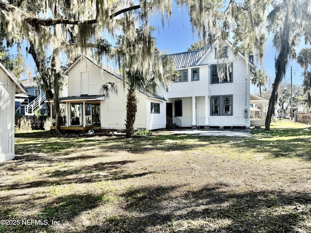 rear view of house with a yard