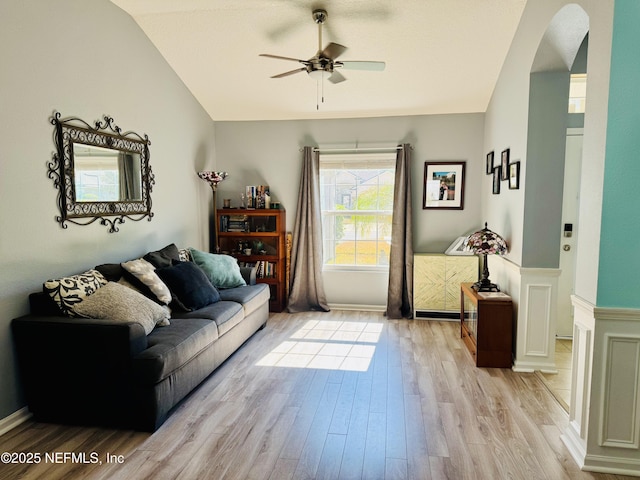 living room featuring lofted ceiling, ceiling fan, and light hardwood / wood-style flooring