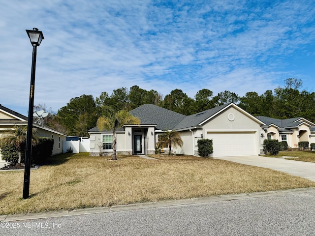 ranch-style house featuring a garage and a front lawn