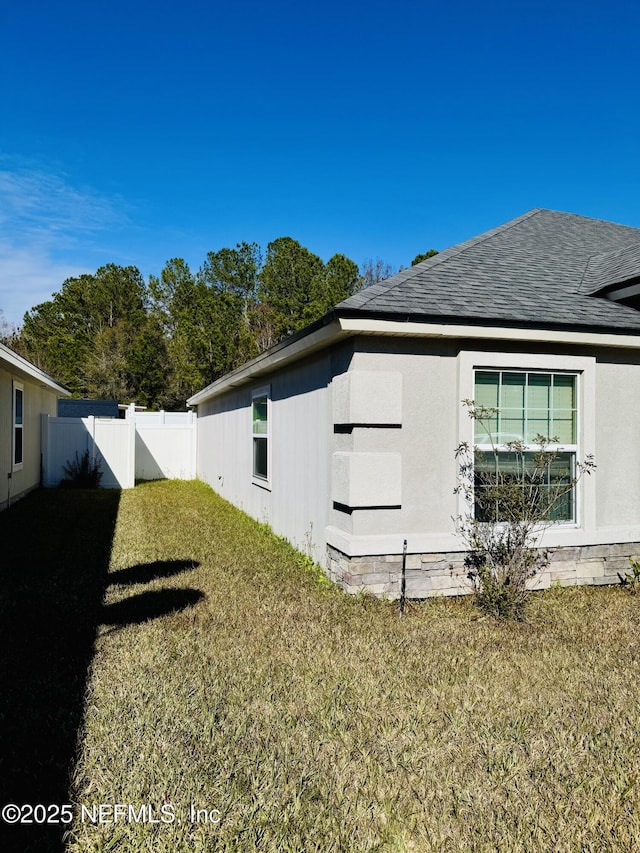 view of side of property with a lawn