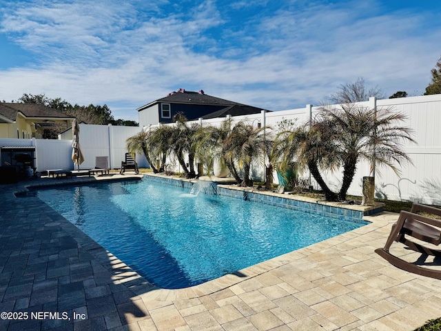 view of pool with pool water feature and a patio area