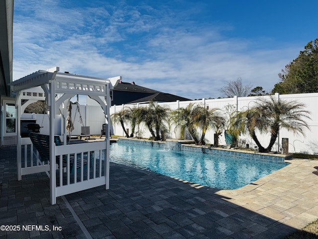 view of pool with a patio area and pool water feature