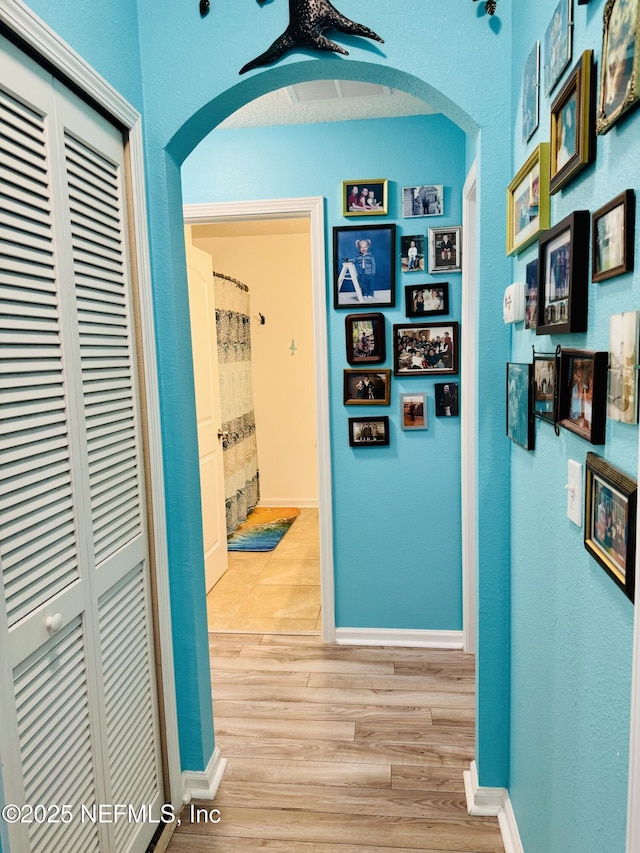 corridor with light wood-type flooring