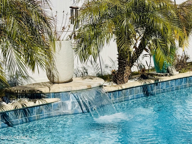 view of swimming pool featuring pool water feature