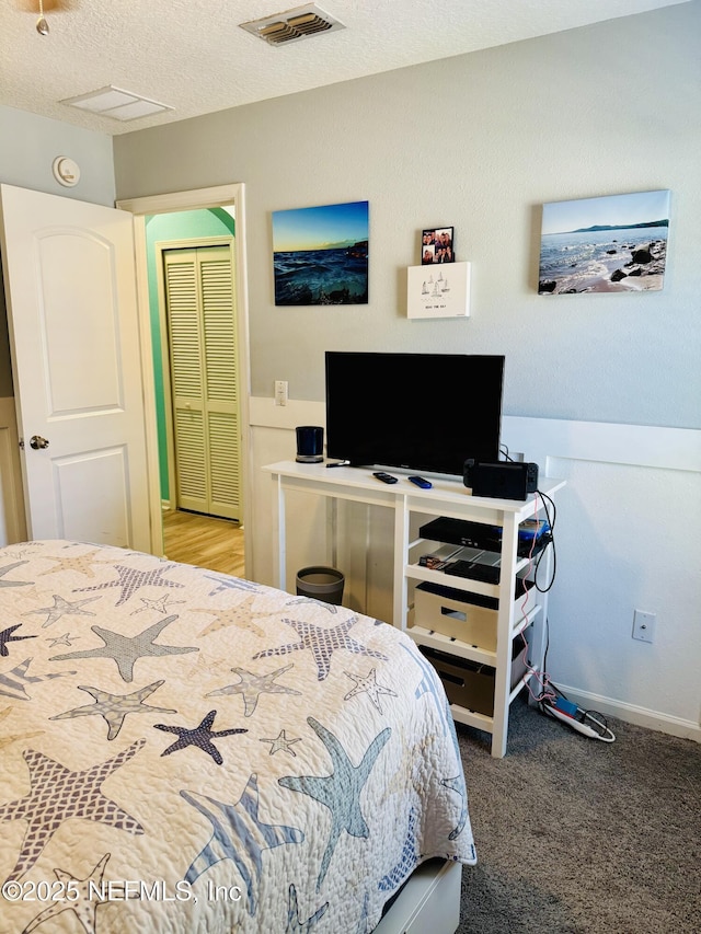 carpeted bedroom with a textured ceiling