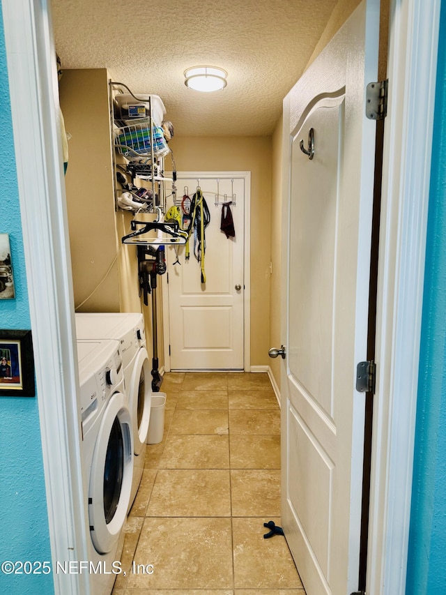 washroom with separate washer and dryer, a textured ceiling, and light tile patterned floors