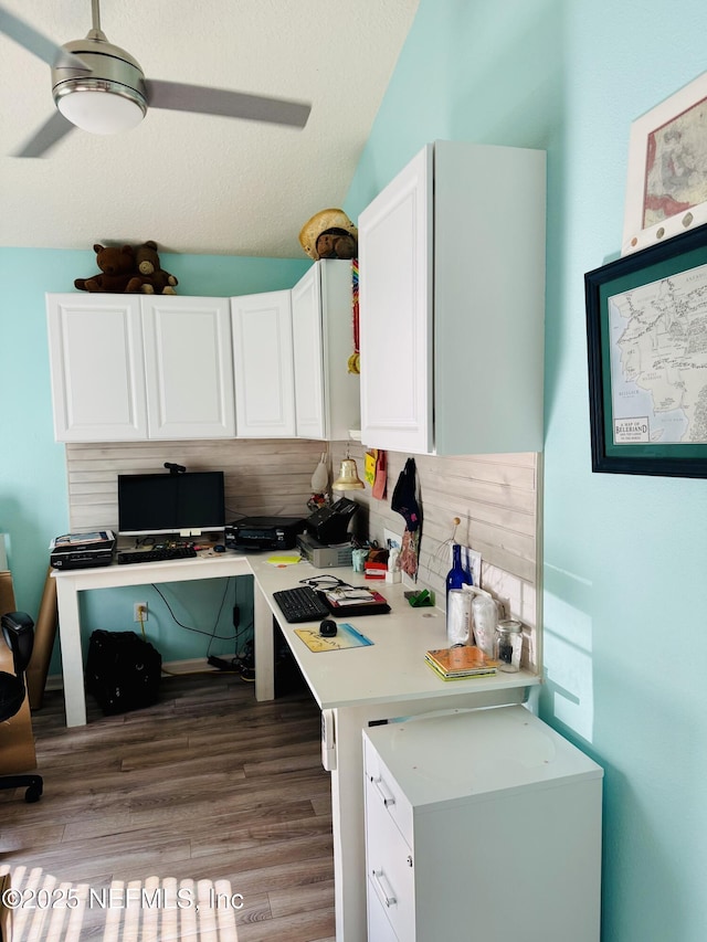 kitchen featuring white cabinetry, tasteful backsplash, a textured ceiling, ceiling fan, and light hardwood / wood-style floors