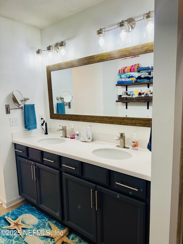 bathroom with vanity, tile patterned floors, and a textured ceiling