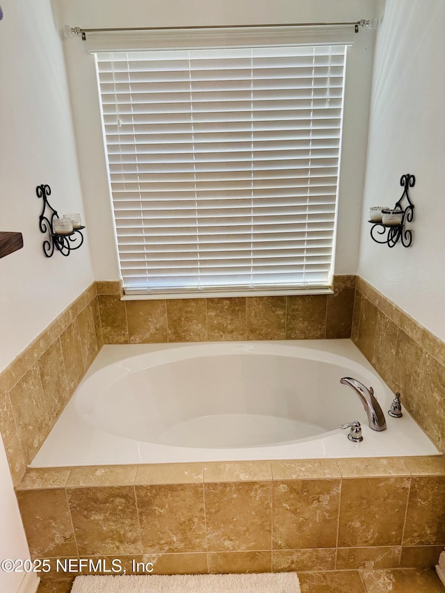 bathroom featuring tiled bath