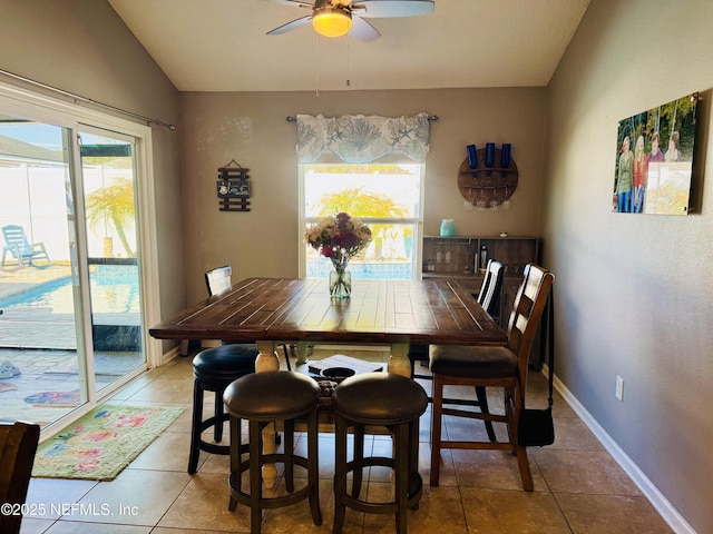 dining area with tile patterned flooring, lofted ceiling, and ceiling fan