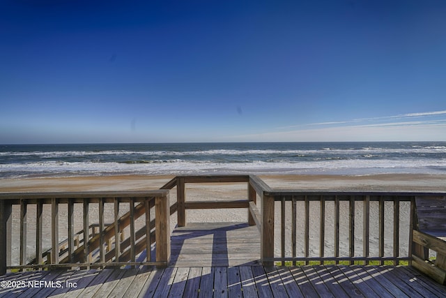 view of home's community with a view of the beach and a deck with water view