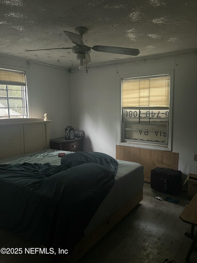 bedroom featuring carpet, a textured ceiling, and ceiling fan