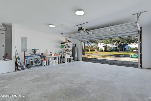 garage with a garage door opener and electric panel