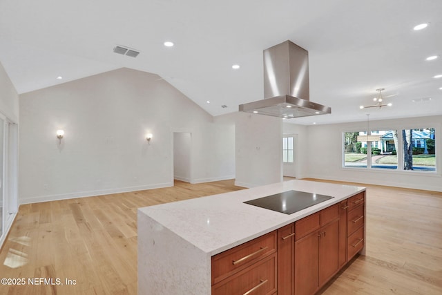 kitchen with light hardwood / wood-style flooring, island range hood, a kitchen island, black electric cooktop, and vaulted ceiling