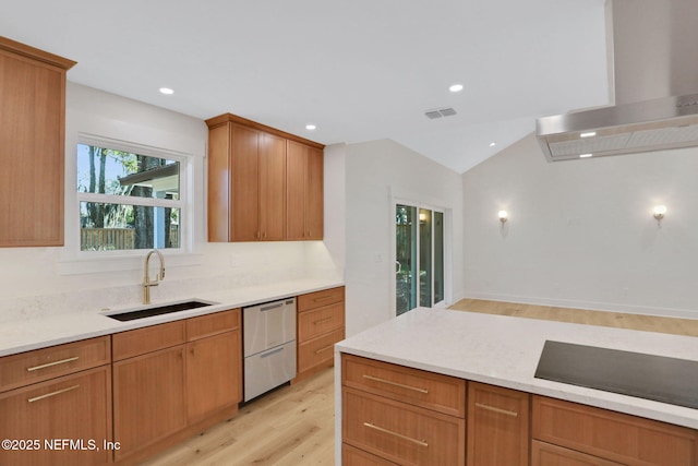 kitchen featuring sink, wall chimney range hood, light hardwood / wood-style flooring, black electric cooktop, and stainless steel dishwasher