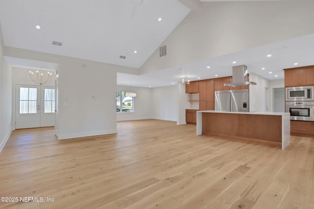 unfurnished living room with high vaulted ceiling, beamed ceiling, a chandelier, light wood-type flooring, and french doors