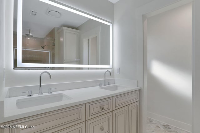 bathroom with vanity and tiled shower