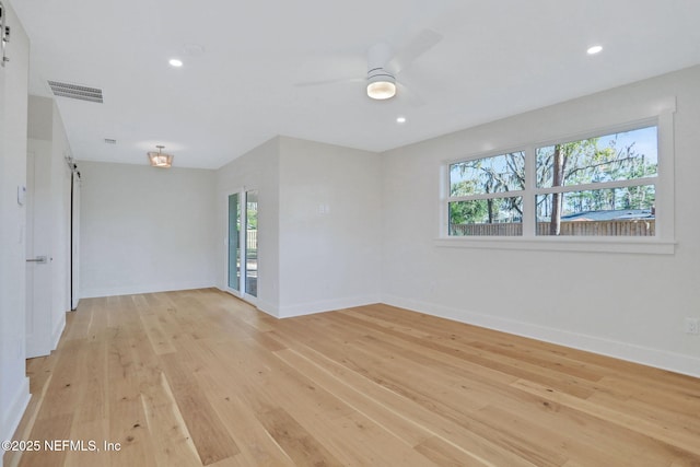 unfurnished room featuring ceiling fan, a healthy amount of sunlight, and light hardwood / wood-style floors