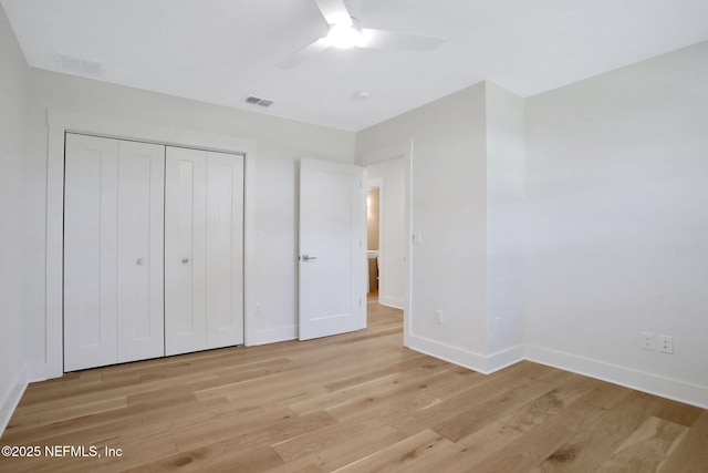 unfurnished bedroom with ceiling fan, light hardwood / wood-style floors, and a closet