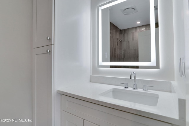 bathroom with walk in shower and vanity