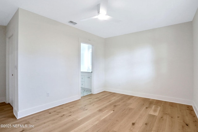 empty room with ceiling fan and light wood-type flooring