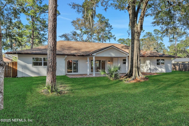 back of house with a lawn