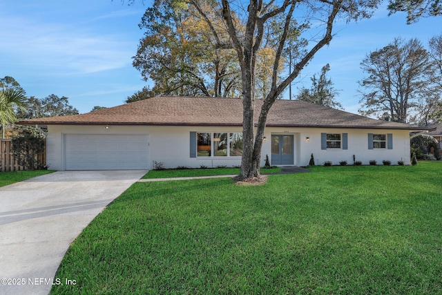 ranch-style house featuring french doors, a garage, and a front lawn