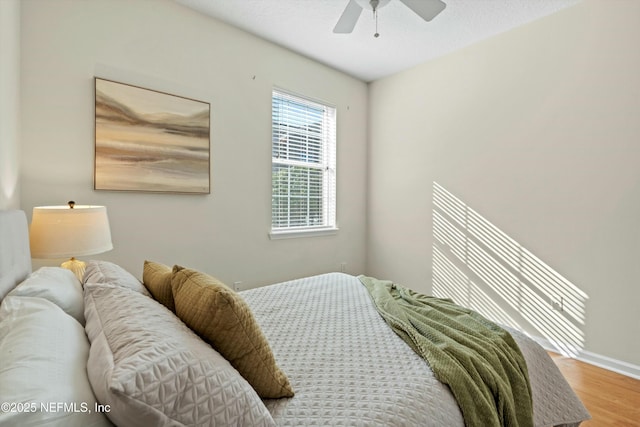 bedroom with ceiling fan and hardwood / wood-style floors