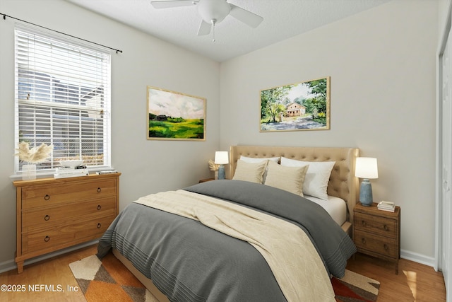 bedroom featuring ceiling fan and light hardwood / wood-style floors