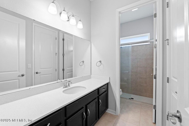 bathroom with tile patterned flooring, toilet, vanity, and walk in shower