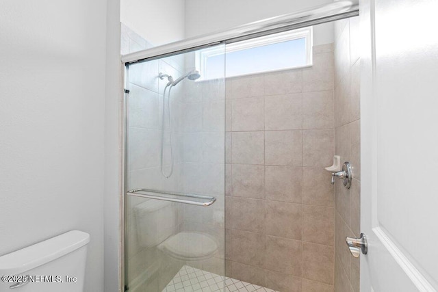 bathroom with toilet and walk in shower