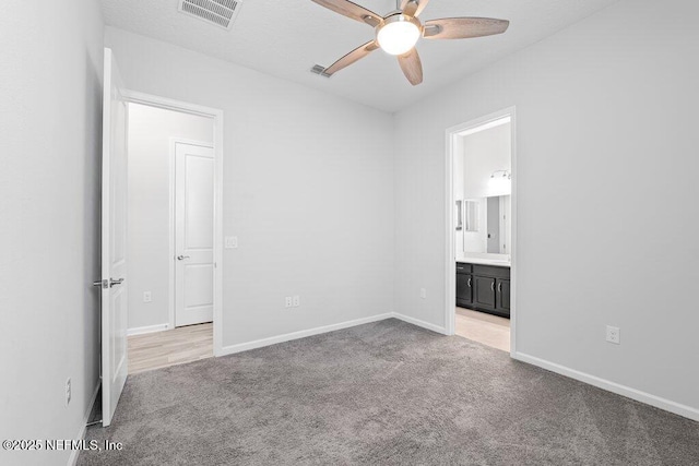 carpeted spare room with ceiling fan