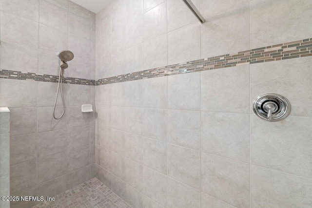 bathroom with a tile shower