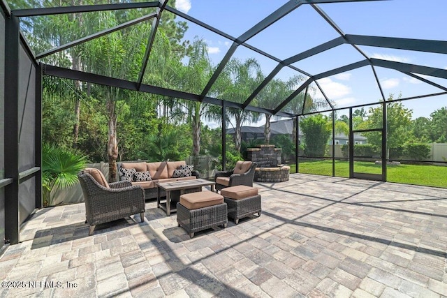 view of patio / terrace with an outdoor living space and glass enclosure