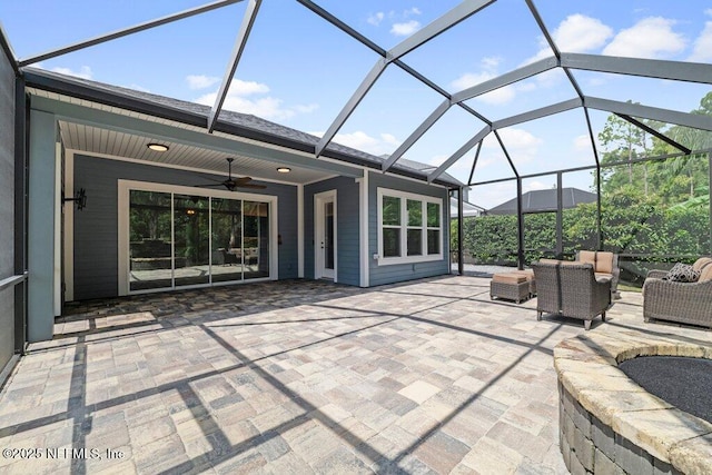 view of patio / terrace featuring ceiling fan, outdoor lounge area, and glass enclosure