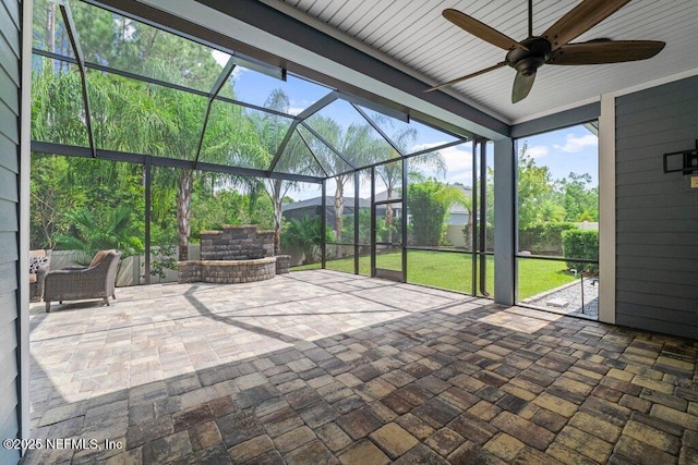 unfurnished sunroom featuring ceiling fan